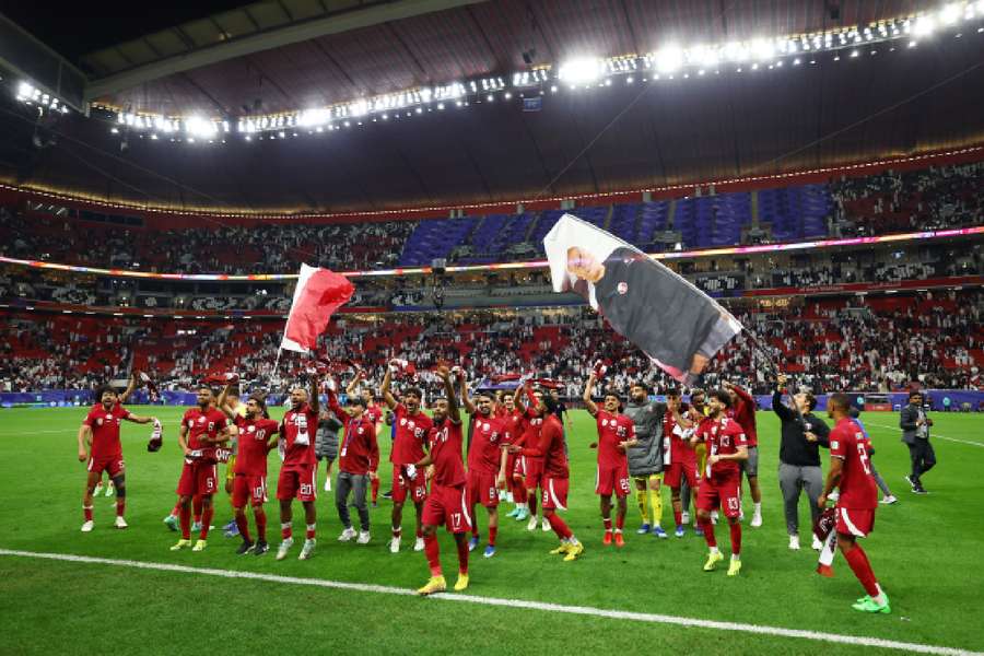 Qatar players celebrate after the match