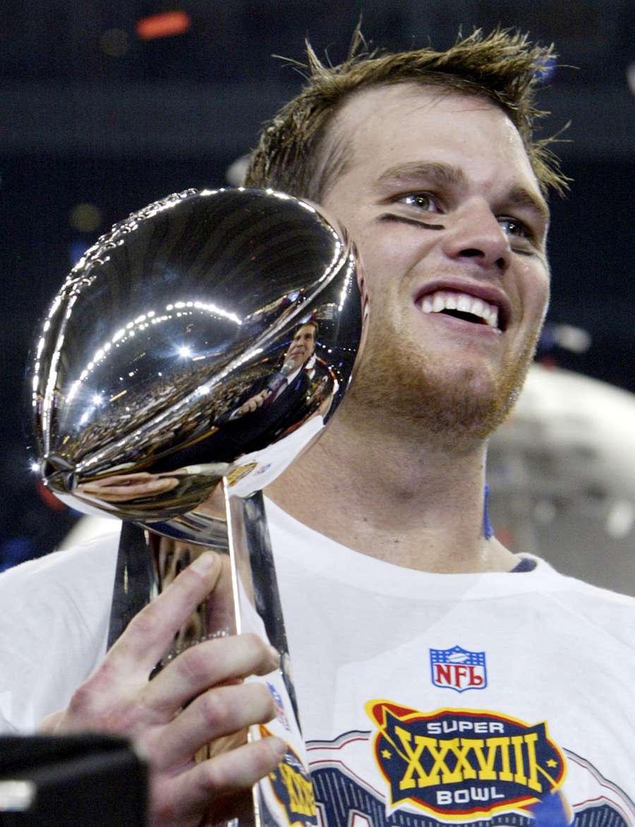 Quarterback Tom Brady of the New England Patriots holds the Vince Lombardi trophy after winning Super Bowl XXXVIII