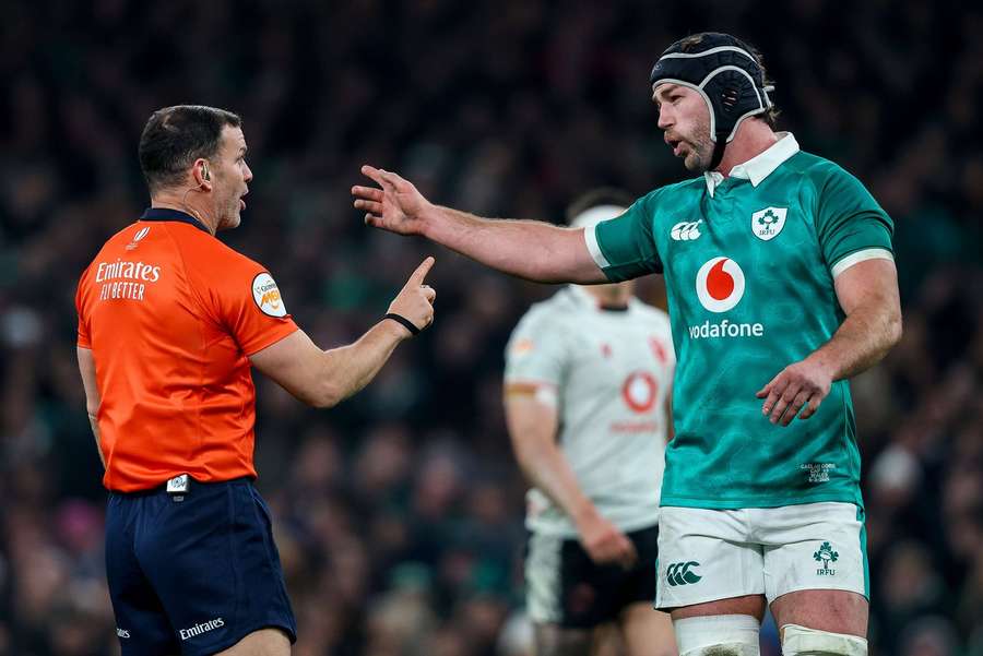 Doris (R) speaks with the referee