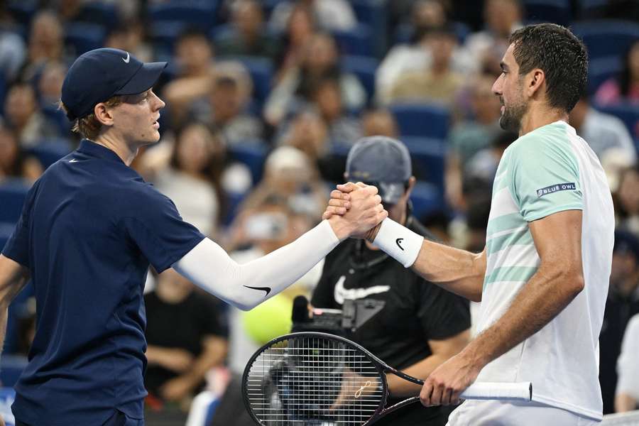 Jannik Sinner and Marin Cilic embrace at the net