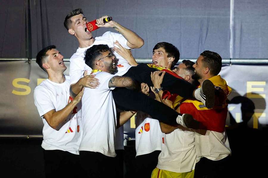 Morata is lofted in the air during celebrations
