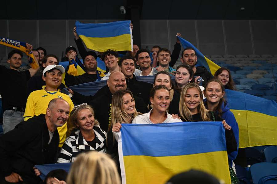 Ukraine's Marta Kostyuk poses with fans in Melbourne