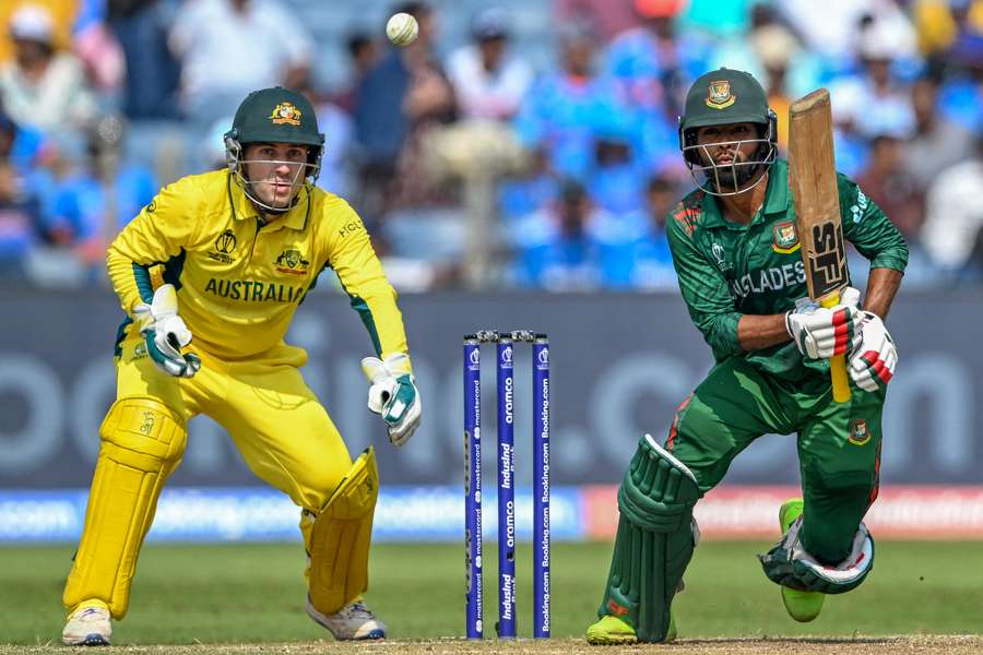 Bangladesh's Towhid Hridoy (R) plays a shot as Australia's Josh Inglis watches