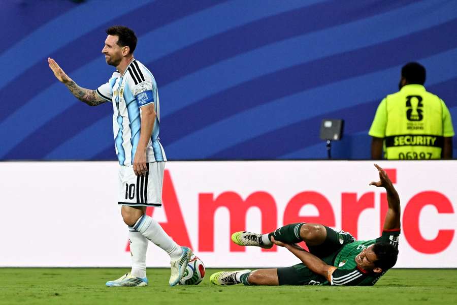 Argentina's Lionel Messi (left) gestures to the referee after his foul on Algeria's Aissa Mandi Argentina's Lionel Messi (left) gestures to the referee after his foul on Algeria's Aissa Mandi