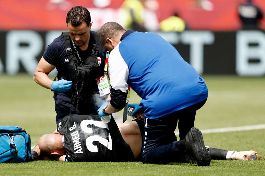 Iraq's Ahmed Basil receives medical attention after sustaining an injury in the first half
