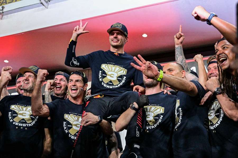 Red Bull's Max Verstappen (C) celebrates his third world championship with his team