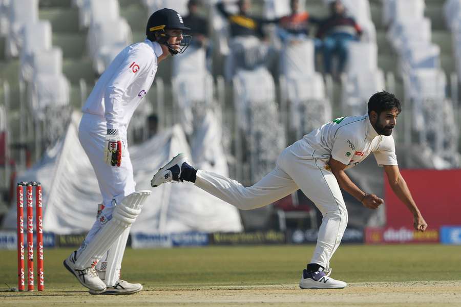 Pakistan's Haris Rauf (R) bowls during the first day of the Test between Pakistan and England