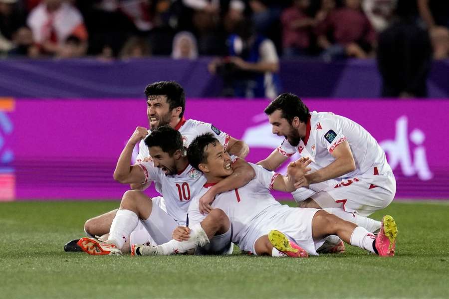 Tajikistan's players celebrate scoring against Lebanon