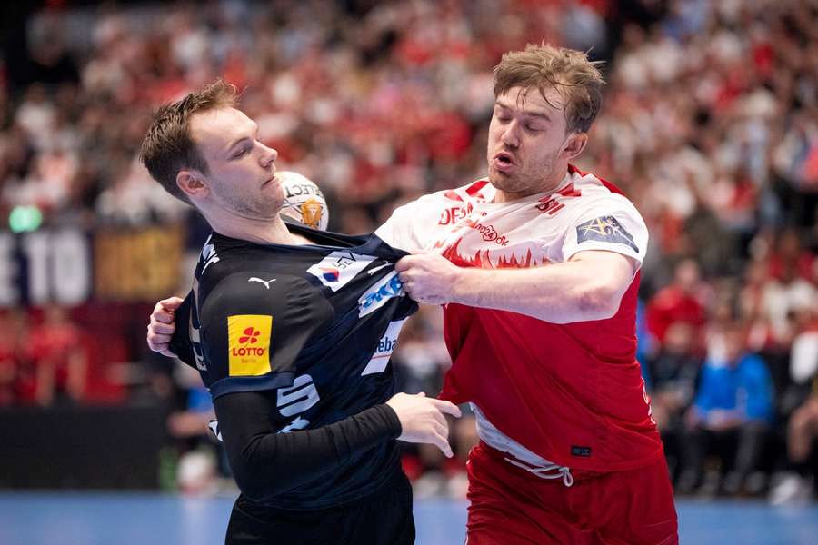 Fuchse Berlin's Mathias Gidsel (L) in action against Aalborg's Thomas Arnoldsen during the EHF Champions League quarter-finals