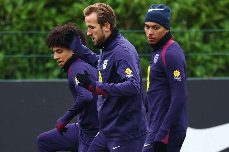 Harry Kane in training alongside Rico Lewis, left, and Morgan Rogers