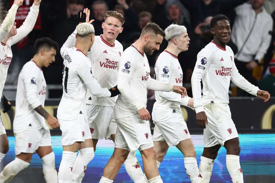 Scott McTominay (C) celebrates with teammates after scoring their third goal