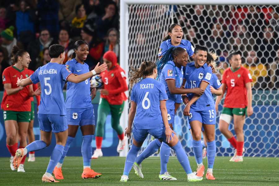 France's midfielder #15 Kenza Dali (R) celebrates with teammates scoring her team's second goal 