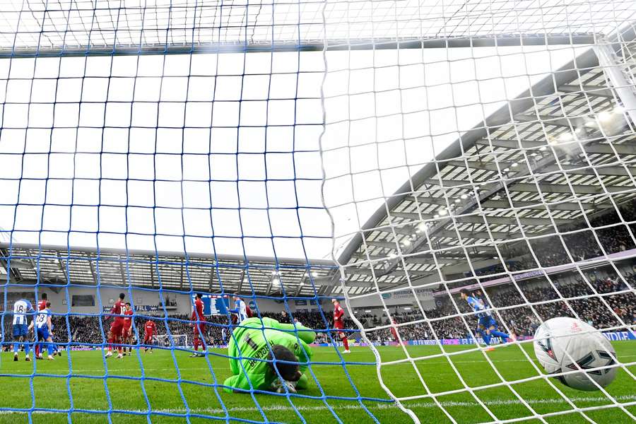 Alisson Becker reacts after a deflection from Brighton's English defender Lewis Dunk beats him for Brighton's first goal 