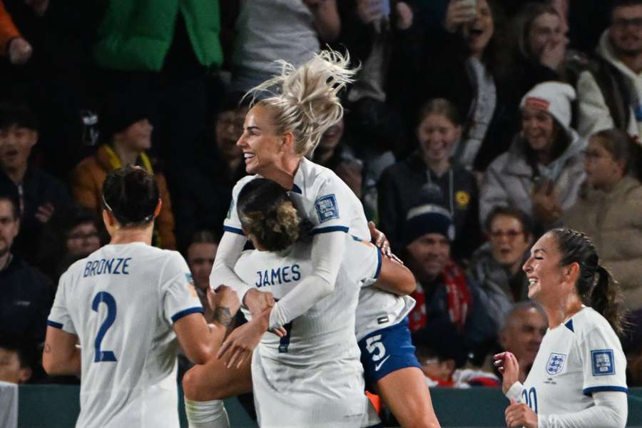 England's forward #07 Lauren James celebrates with her teammates after scoring her team's third goal