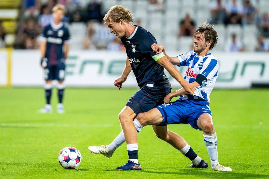 Mads Emil Madsen and OB's Rasmus Falk battle for the ball