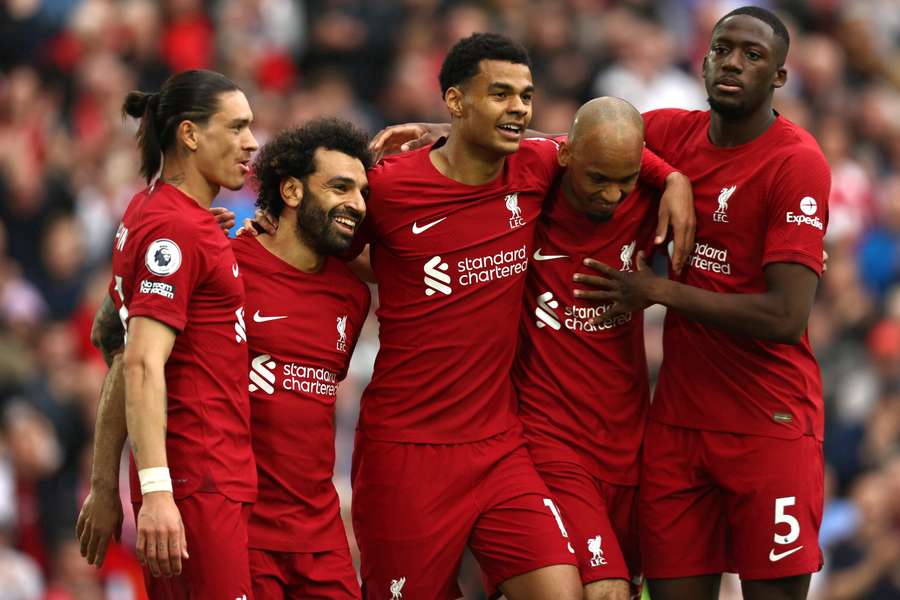 Liverpool's Egyptian striker Mohamed Salah celebrates with teammates after scoring his 100th Anfield goal