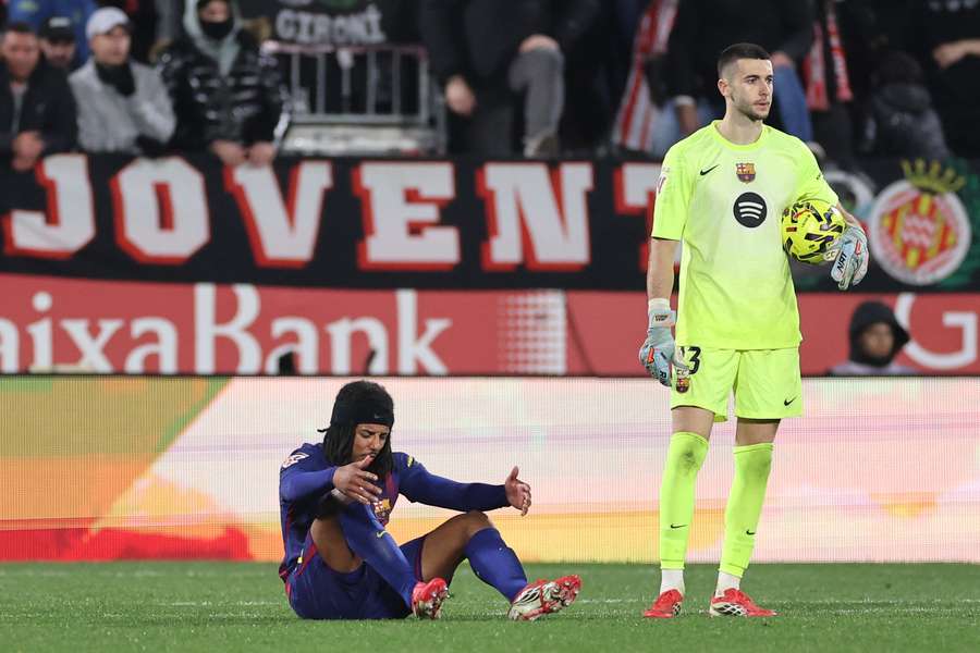 Joan Garcia and Jules Kounde look dejected after Barcelona conceded a late goal in their loss to Girona.