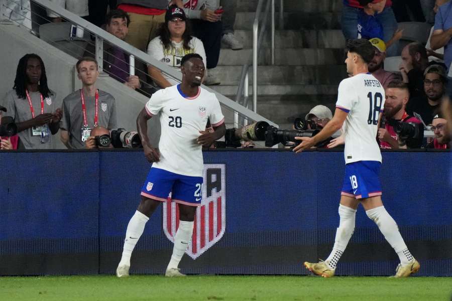 Baloguncelebrates scoring for USA