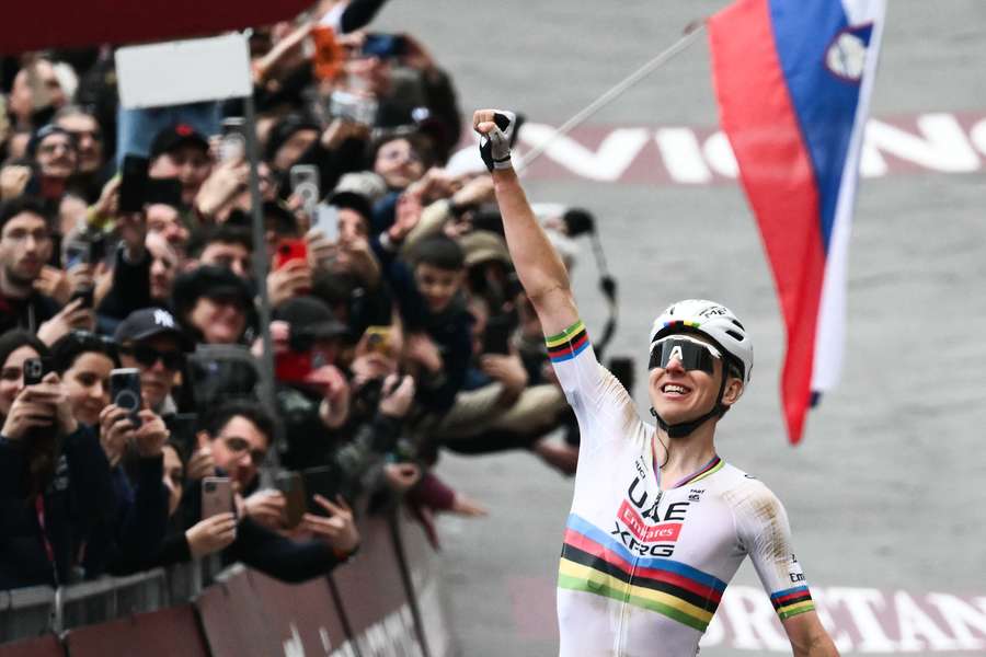 UAE Team Emirates's Tadej Pogacar celebrates as he crosses the line to win the Strade Bianche
