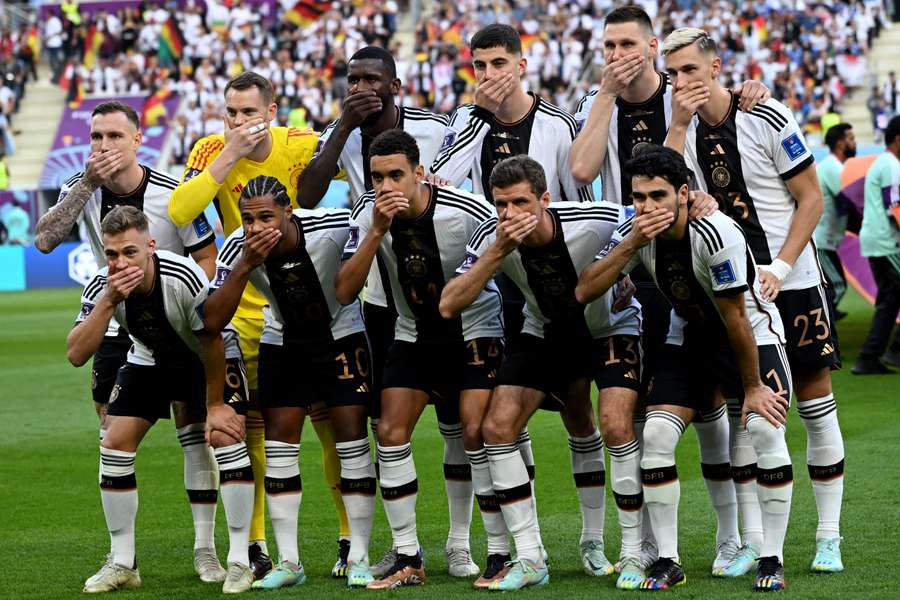 Germany players cover mouths in protest ahead of their Group E match against Japan