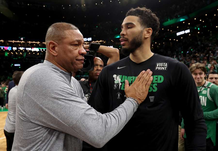 Head coach Doc Rivers of the Philadelphia 76ers congratulates Jayson Tatum of the Boston Celtics