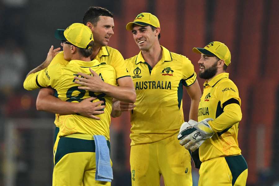 Australia captain Pat Cummins celebrates with teammates after beating England