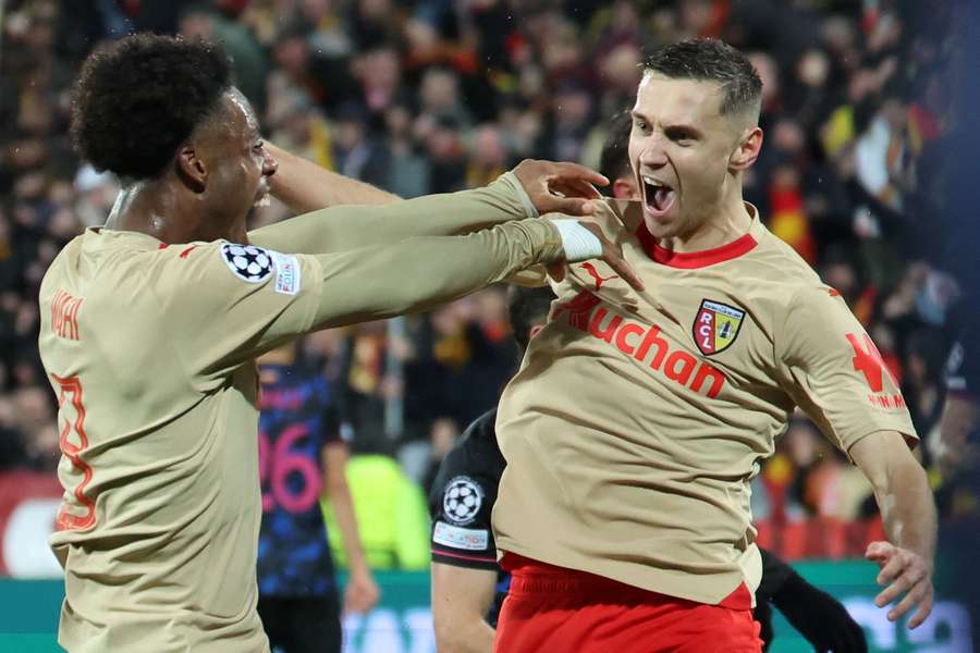 Przemyslaw Frankowski celebrates giving Lens the lead against Sevilla