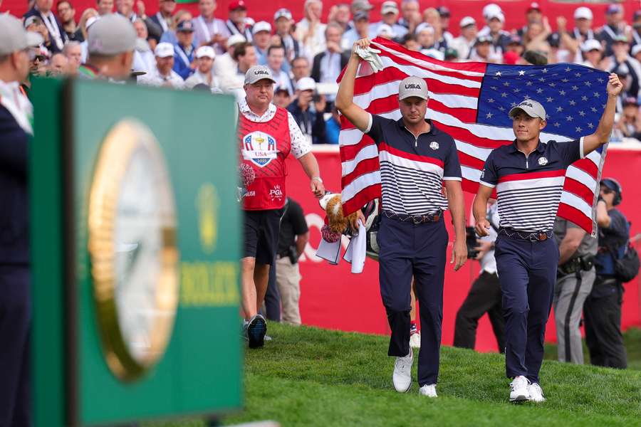 Collin Morikawa (r) arrives for day one of the Ryder Cup