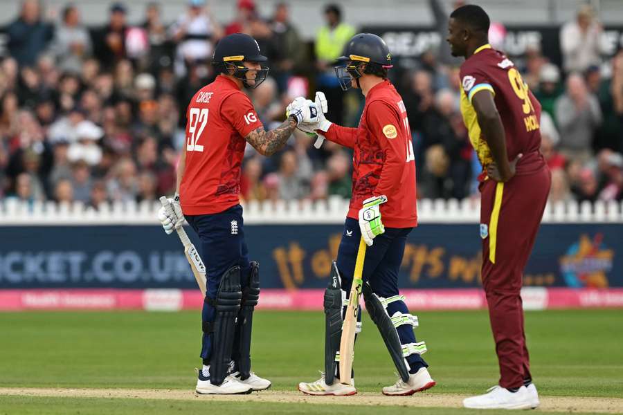 England's Brydon Carse (L) and Tom Banton (C) celebrate their win against the West Indies