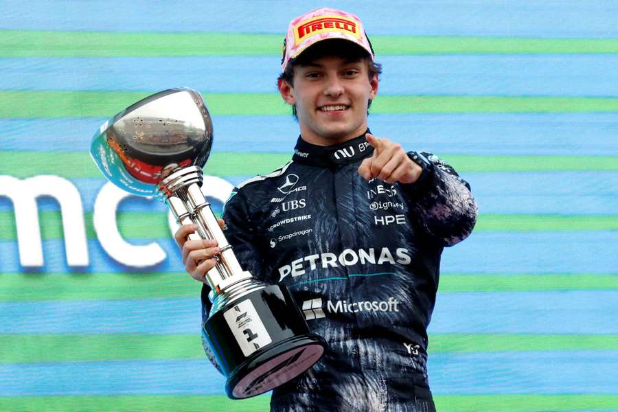 Mercedes' Andrea Kimi Antonelli celebrates on the podium with the trophy after winning the Japanese Grand Prix