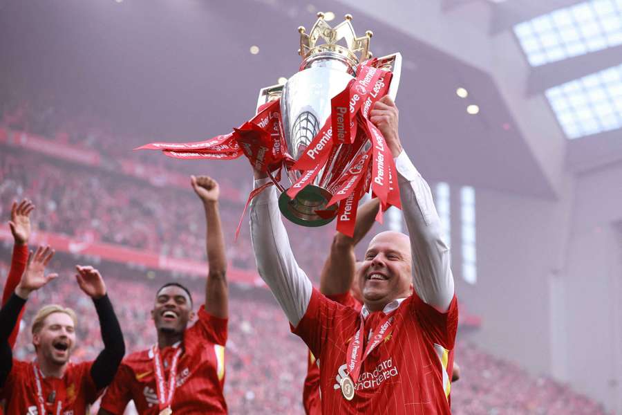 Arne Slot lifts the Premier League trophy at Anfield