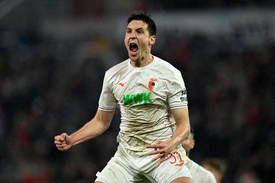 Keven Schlotterbeck of FC Augsburg celebrates scoring the opening goal