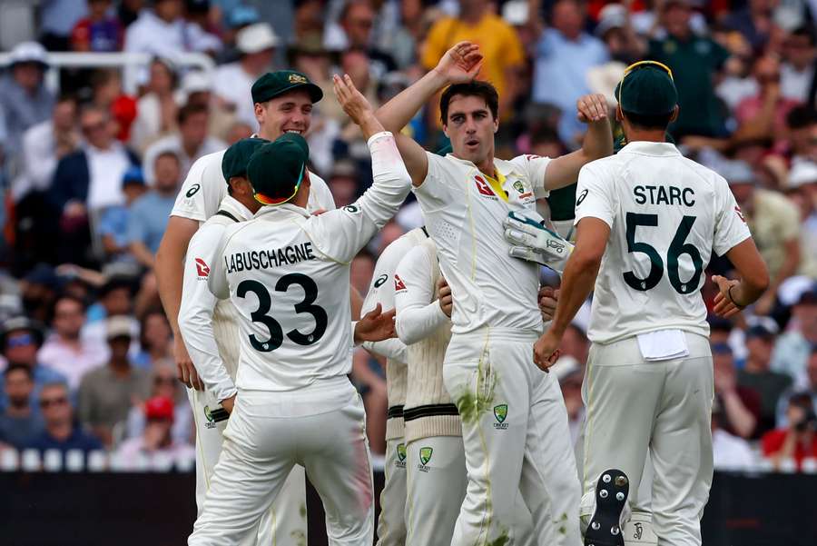 Australia's Pat Cummins (C) celebrates with teammates after bowling England's Harry Brook