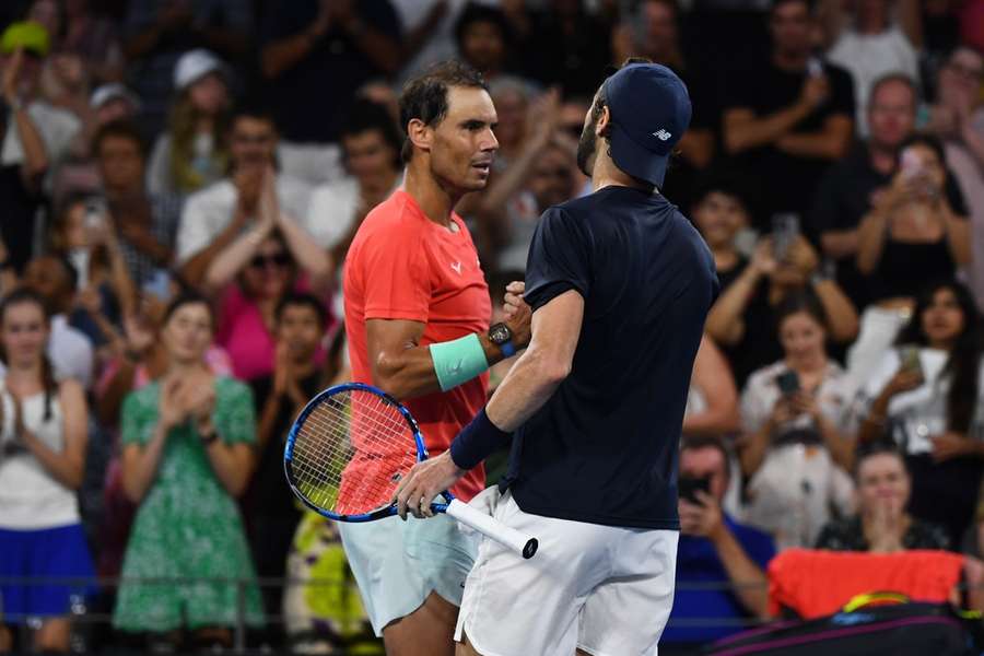Nadal shakes hands with Thompson after the match