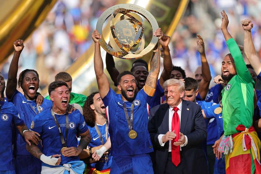 Chelsea's Reece James holds the Club World Cup trophy aloft alongside US President Donald Trump