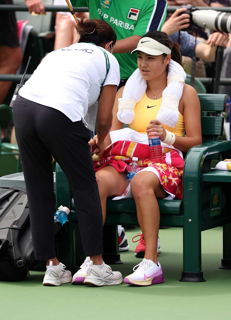 Emma Raducanu of Great Britain receives treatment in her match against Magda Linette