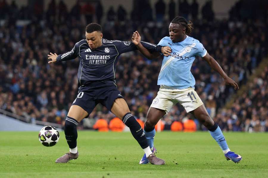 Manchester City midfielder Jeremy Doku, right, in action during a defeat by Real Madrid in a Champions League last-16 second leg