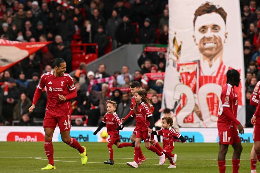 The sons of Liverpool's late Portuguese forward Diogo Jota, Dinis and Duarte and other family members take part in pre-game activities to honour the player who represented both Wolves and Liverpool