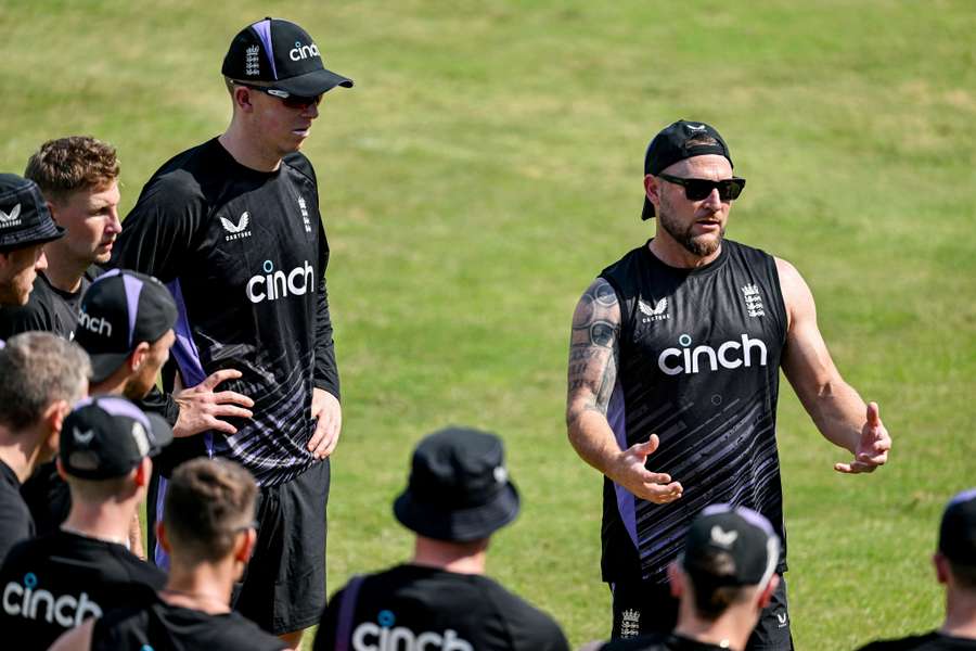 Coach Brendon McCullum speaks to his players