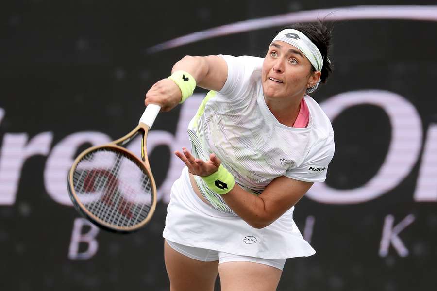 Ons Jabeur of Tunisia serves to Belinda Bencic of Switzerland during the Finals of the Credit One Charleston Open