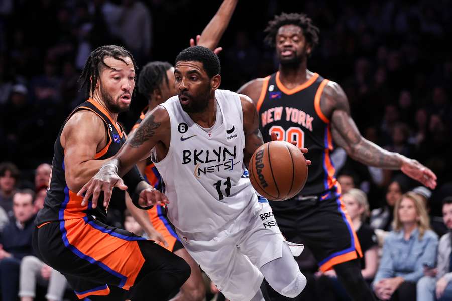 Kyrie Irving #11 of the Brooklyn Nets is guarded by Jalen Brunson #11 of the New York Knicks during the fourth quarter 