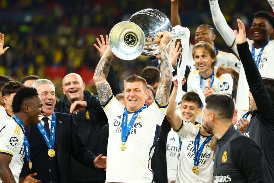 Toni Kroos holds up the trophy