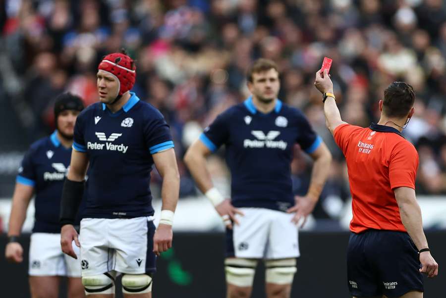 Scotland lock Grant Gilchrist (L) reacts after being issued a red card