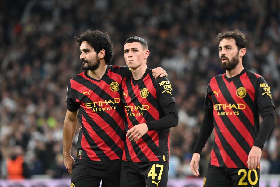 Manchester City players Ilkay Gundogan, Phil Foden and Bernardo Silva (L-R) leave the pitch