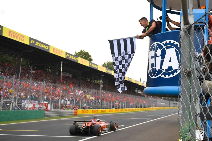 Ferrari's Monegasque driver Charles Leclerc drives past the chequered flag to win the Italian Formula 1 Grand Prix
