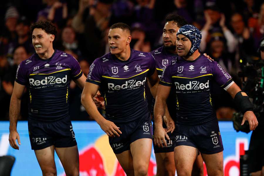 Melbourne Storm trio Jahrome Hughes, Nick Meaney and Will Warbrick celebrate a try in their preliminary final win over Cronulla. 
