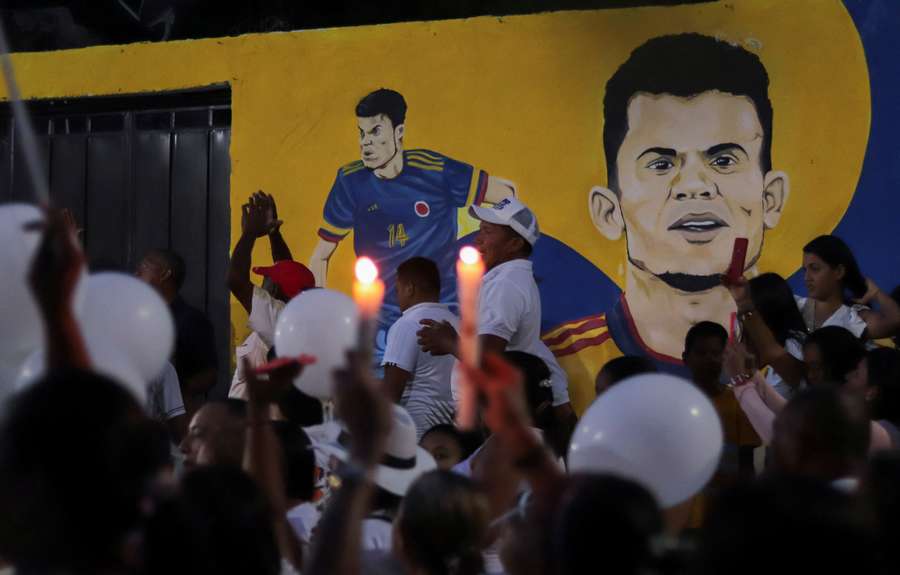 People attend a candlelight vigil demanding the release of the father of Luis Diaz