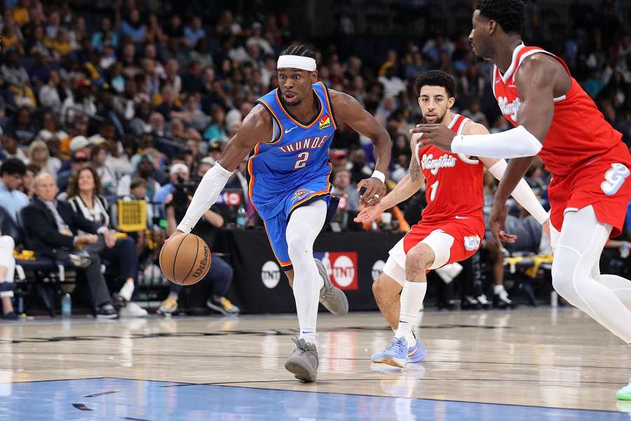 Shai Gilgeous-Alexander of the Oklahoma City Thunder handles the ball against Jaren Jackson Jr. of the Memphis Grizzlies