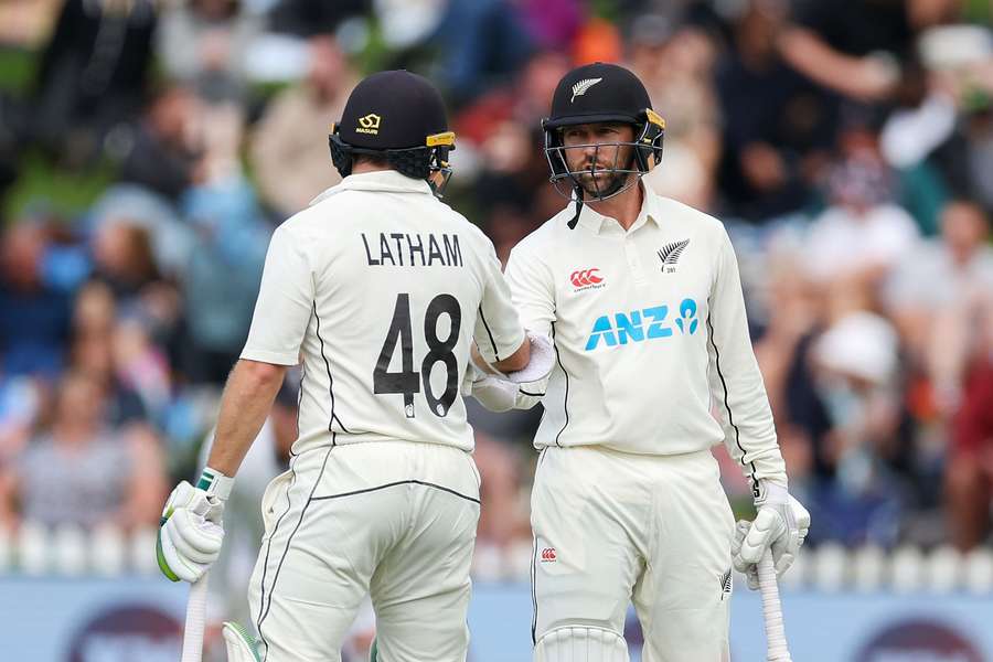 New Zealand's Devon Conway (R) celebrates 50 runs with teammate Tom Latham