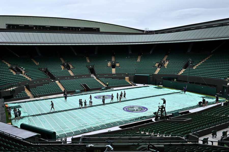 Members of staff prepare Court 1 for the start of the Wimbledon Championships